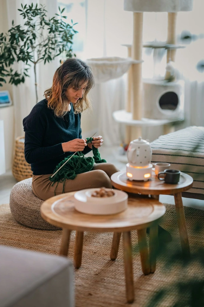 A woman sitting on a stool in a living room